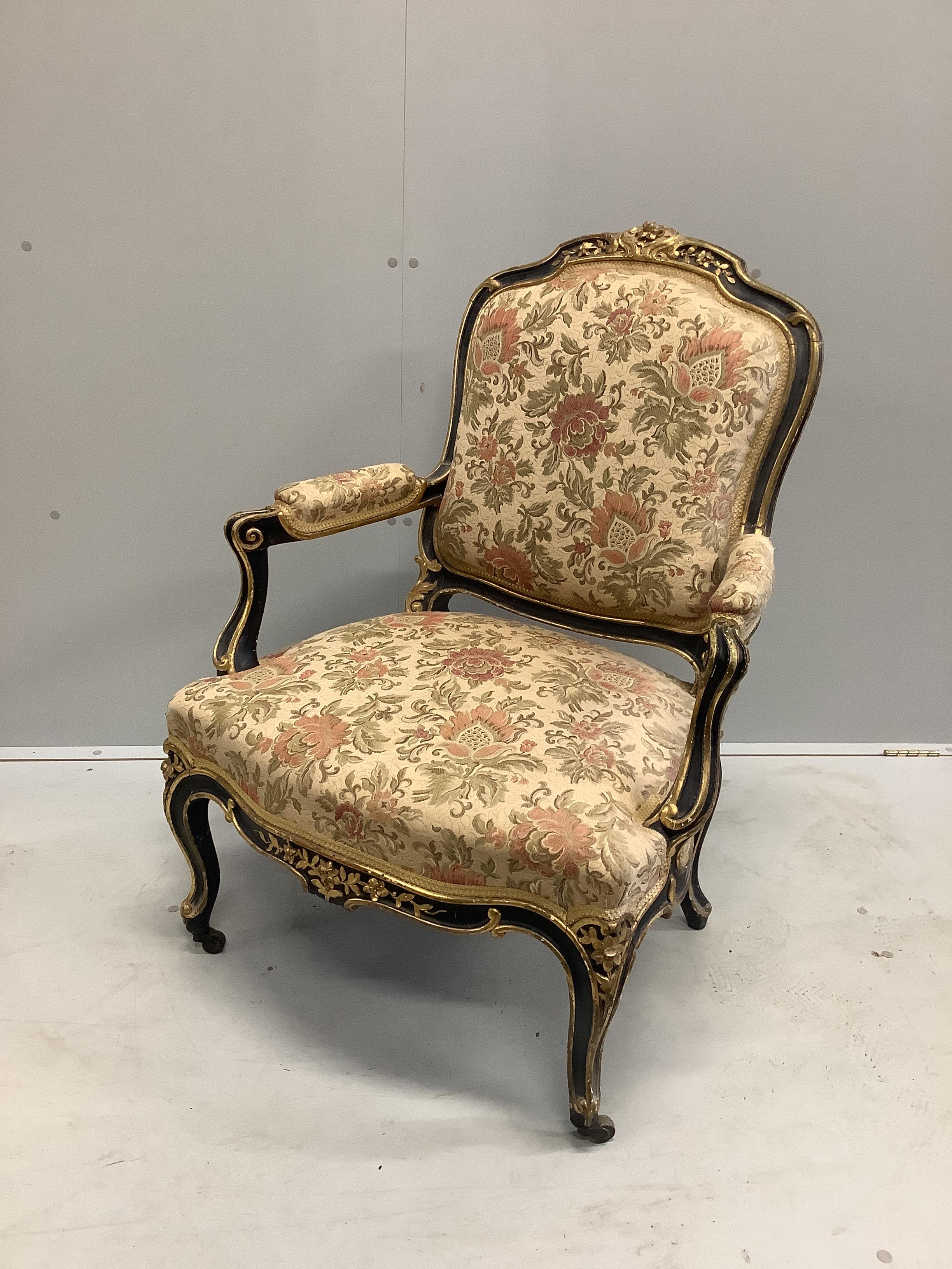 A Victorian gilt and ebonised upholstered open armchair, width 75cm, depth 60cm, height 96cm